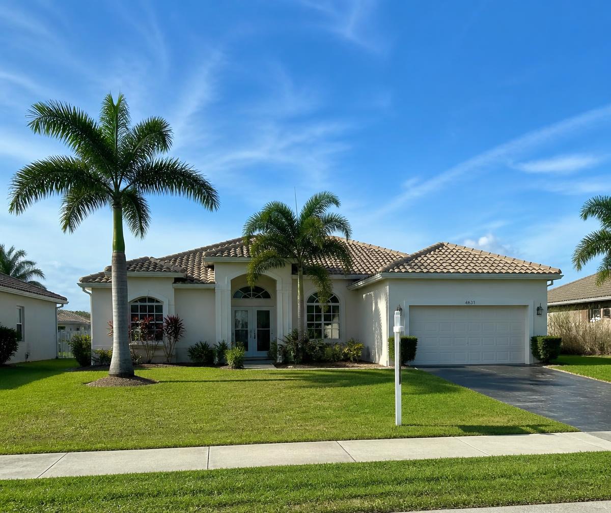 Single-story Southwest Florida home with palm trees in a Cape Coral neighborhood